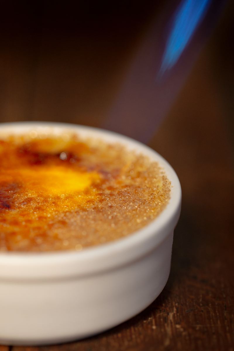 Crème brûlée being caramelised with a blowtorch