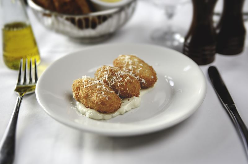 Croquettes topped with grated cheese