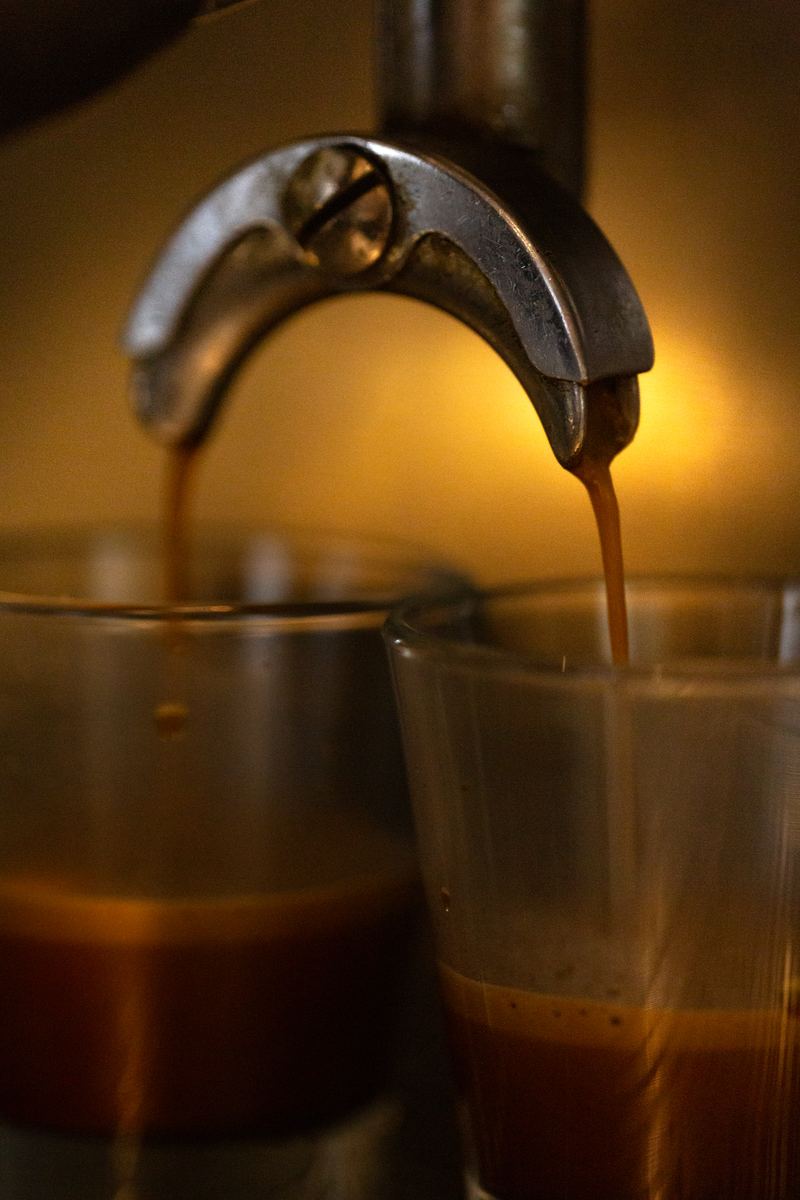 Espresso pouring from the machine into two glasses