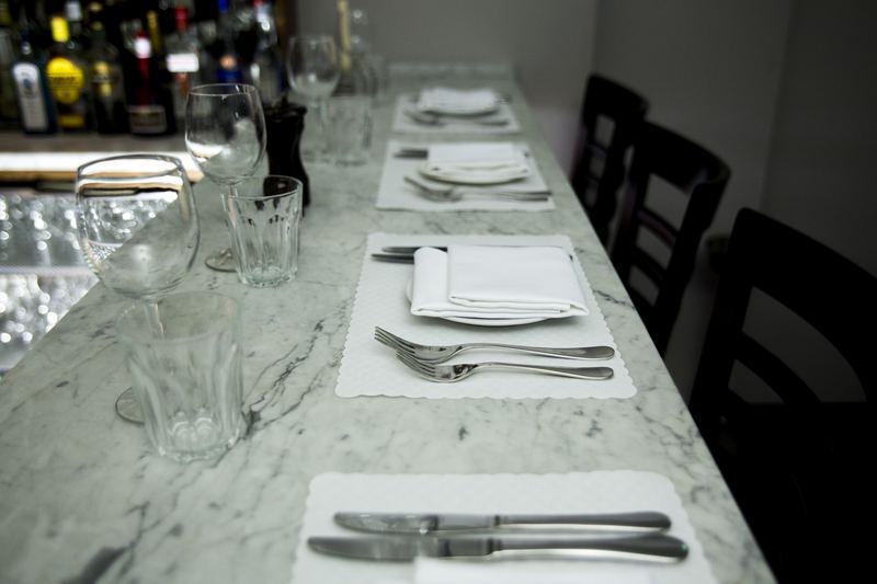 Place settings along the marble bar counter