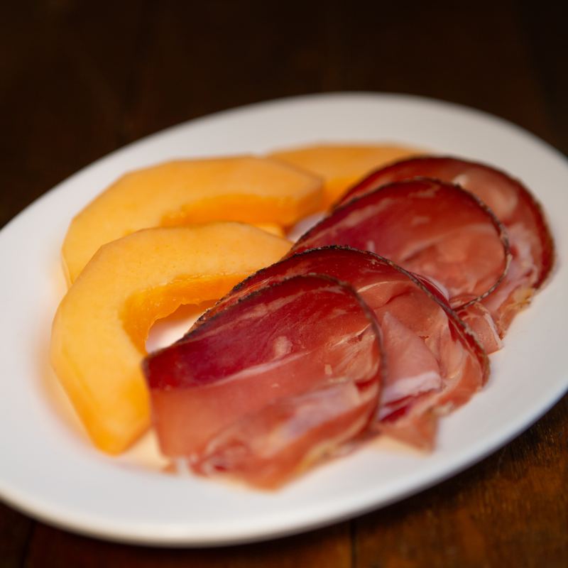 Slices of melon with cured ham